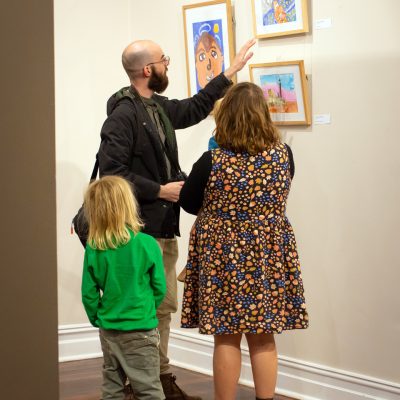 James Swanborough and his family looking at Jacob Almeida’s art work at Heart and Soul of the Country opening event.